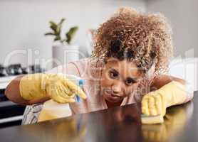 I dont give dust the time of day. a young woman cleaning a countertop at home.