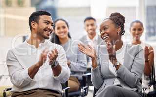 Personally, I thought it was great. a group of businesspeople applauding while sitting in the office during a conference.