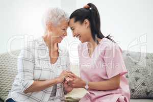 The honour of friendship. a young nurse caring for an older woman inside.