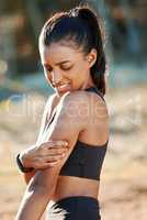 Its a struggle building muscle. a young woman experiencing muscle pain while working out in nature.