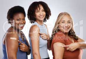 You cant enjoy abundance of wealth if youre not in good health. Studio shot of a group of people wearing plasters after getting the Covid-19 vaccine against a grey background.