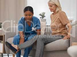 Does the pain feel worse when you flex your ankle. a doctor examining a senior womans ankle on the sofa at home.