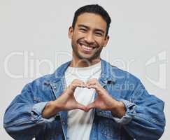 Much love. Cropped portrait of a handsome young man making a heart gesture in studio against a grey background.