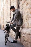 Looks like Im taking my bike today. a young businessman using a bike in the city.