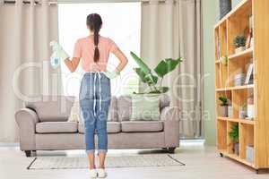 Looks as good as new. a young woman holding a bottle while getting ready to do chores at home.