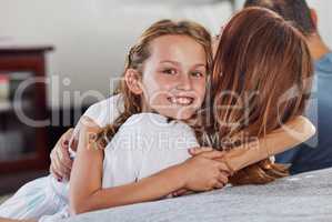 Im a mommys girl for sure. an adorable little girl hugging her mom during a day at home.