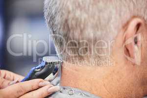 Theres a craft to cutting hair. a man getting a haircut in a salon.