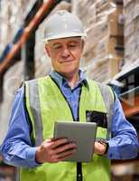 You cant succeed without some hard work. a mature man using a digital tablet while working in a warehouse.