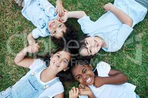 Its always a great day when I have my friends around. four adorable kids lying together on the lawn.