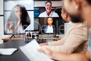 Technology has the ability to bridge the gap. a diverse group of businesspeople sitting in the boardroom during a meeting with their international colleagues via video chat.