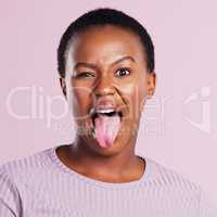 Come join the wild side. Studio shot of a young woman making a silly face against a pink background.