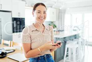 Making those necessary weekend plans. an attractive young woman standing alone and using her cellphone to work from home.