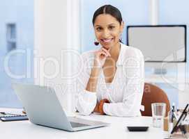 Success comes from hard work. a young businesswoman sitting at a desk in a modern office.