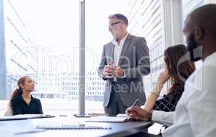 Persistence guarantees that results are inevitable. a group of businesspeople having a meeting in a modern office.