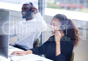 Our friendly agents are ready to assist you. a young businesswoman working in a call centre.