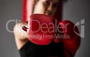 Theres power in those punches. Closeup shot of an unrecognizable young female boxer training in the gym.