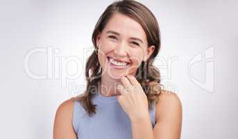 Theres always a reason to smile - find it. Studio portrait of a happy young woman posing against a grey background.