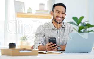 Call me Mr Positivity. a young man using his cellphone at work in a modern office.