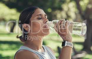Remember to hydrate when working out. a young woman taking a break during a workout to drink water.