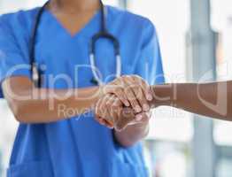 Trusted care for when you need someone to be there. an unrecognisable doctor holding hands with her patient during a consultation.