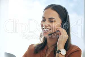 Let me access your account right now. an attractive young saleswoman sitting alone in her office and wearing a headset.