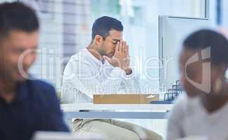 Today might not be your day but try again tomorrow. Defocused shot of a businessman looking stressed while sitting at his desk.