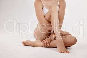 Owning your femininity is owning your power. frontal shot of a woman in underwear, with a white background.