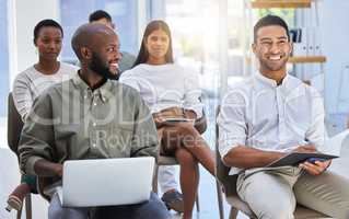 Squad moral is high. a two young men smiling at a working meeting in a modern office.