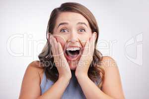 Youre gonna make me scream with joy. Studio portrait of a young woman looking surprised against a grey background.