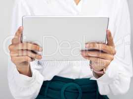 Upgrade your tech, upgrade your business. Studio shot of an unrecognisable businesswoman using a digital tablet against a grey background.