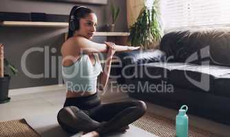 Its time to unwind your mind. a young female fitness trainer getting ready to live stream her workout at home.