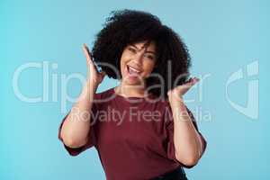 Not all crowns are made of gold. Studio shot of an attractive young woman posing against a blue background.