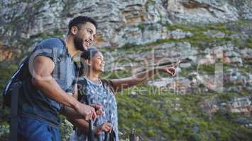 Such stunning scenic views from the mountain today. a young couple enjoying the sunset view while out on a hike on a mountain range.