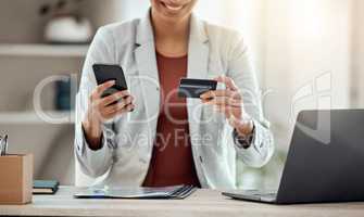 Credit card and phone for shopping, buying and paying for products online on an app while sitting at work. Cheerful, excited and joyful professional banking, making payments and organizing finances