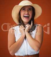 Theres nothing more beautiful than the sound of laughter. Studio shot of a stylish young woman posing against a brown background.