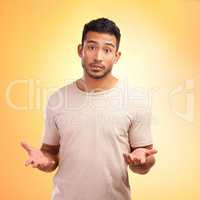 How should I know. a young man looking unsure while standing against a yellow background.