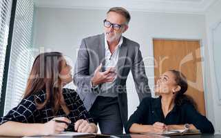 Success is the offspring of audacity. a group of businesspeople having a meeting in a modern office.