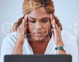 Stressed, frustrated and unhappy business woman suffering from a headache or migraine and feeling tired at the office. Depressed entrepreneur struggling to focus after a mistake or slow internet