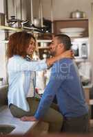 The kitchen truly is the heart of a home. Shot of a young couple sharing a romantic moment in the kitchen.