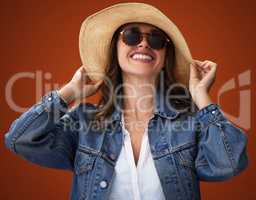 To look good, one must feel good. Studio shot of a stylish young woman posing against a brown background.