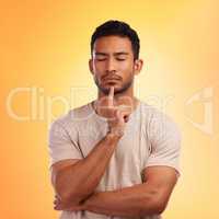 I need some time to think about it. a young man looking thoughtful while standing against a yellow background.