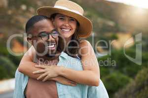 Love makes the world around you come to life. a happy young couple enjoying a piggyback ride on a road trip.