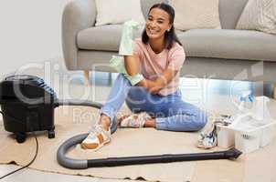 Vacuuming is my favorite chore. a young woman sitting on the floor with a vacuum at home.