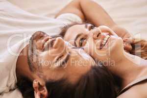 Gaze at the ceiling and make lame jokes. a young couple having an intimate moment on the bed at home.