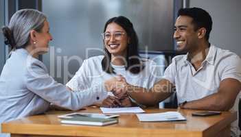 One destination, two cars. a young couple meeting with a consultant to discuss paperwork an office.