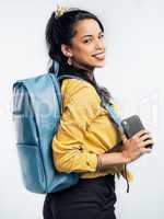 Living life one adventure at a time. Studio shot of a young woman wearing a backpack while standing against a white background.