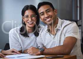 Couple goals is just a phrase without paperwork. Portrait of a young couple completing paperwork at an office.