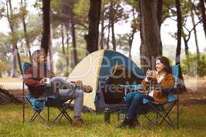 Nature is the perfect place to bond. a young couple camping in the wilderness.