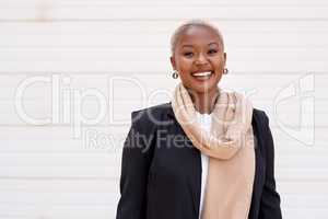 Ive always been optimistic about life. Portrait of a young businesswoman standing against a white background.