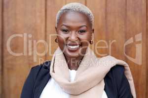 Once you believe in yourself, you can achieve it all. Portrait of a young businesswoman standing against a brown background.